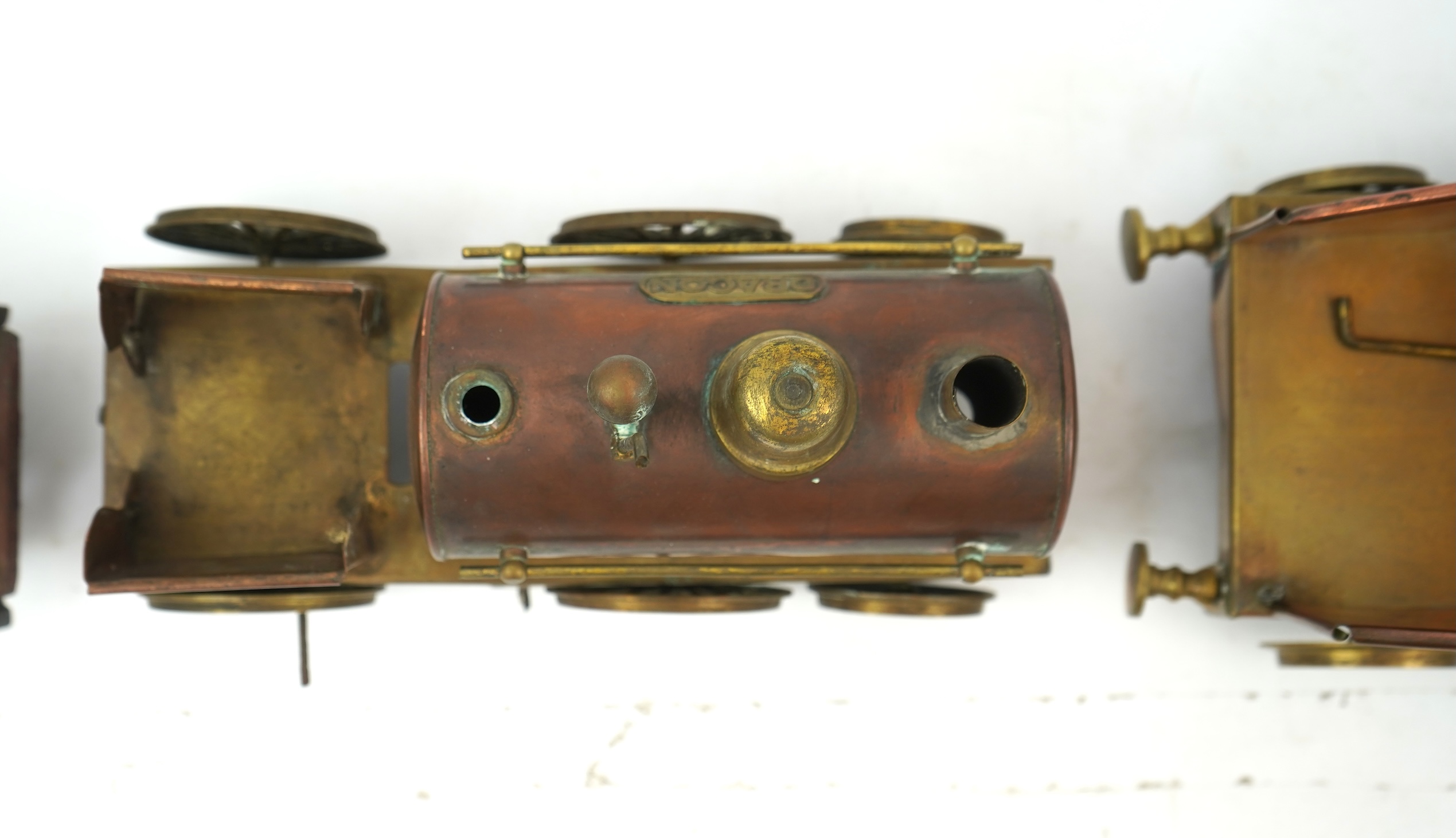 Three late 19th or early 20th century brass and copper live steam locomotives; a 2-2-4, ‘Monarch’, gauged to run on approximately 4 1/2 inch track, 33cm long frames, a 2-2-2, ‘Dragon’, gauged to run on approximately 3 1/